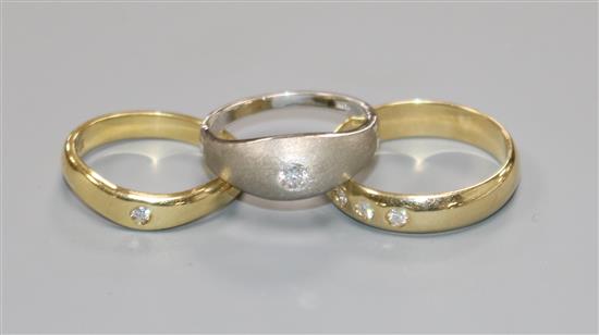 Two 18ct gold and gypsy set solitaire diamond rings including white gold and an 18ct gold and gypsy set three stone diamond ring.
